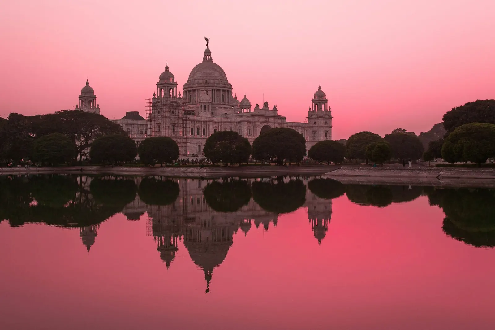 The Victoria Memorial in Kolkata reflected in the water at dusk